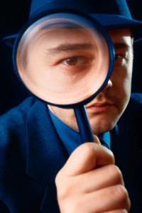 Man Looking through Magnifying Glass